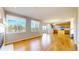 Bright, open-concept living room with hardwood floors and large windows offering a scenic view at 9567 W 107Th Dr, Broomfield, CO 80021