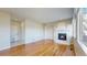 Inviting living room featuring hardwood floors and a cozy fireplace, perfect for relaxation at 9567 W 107Th Dr, Broomfield, CO 80021