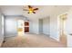 Spacious main bedroom featuring vaulted ceiling, fan, and ensuite bathroom with wood sliding door at 9567 W 107Th Dr, Broomfield, CO 80021