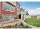 Exterior of a two-story home with a stone foundation, lush lawn and garden area at 1109 Larkspur Dr, Erie, CO 80516