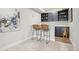 A stylish bar area with a sink, cabinetry, and two modern bar stools at 1109 Larkspur Dr, Erie, CO 80516