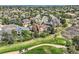 Beautiful aerial view of a neighborhood surrounded by trees and a golf course, providing a serene and picturesque setting at 7083 Turweston Ln, Castle Pines, CO 80108