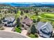 Stunning aerial view of a luxurious home surrounded by lush greenery and a golf course in a scenic neighborhood at 7083 Turweston Ln, Castle Pines, CO 80108