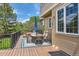 Spacious back deck with outdoor dining furniture and black metal railing, offering a relaxing retreat at 7083 Turweston Ln, Castle Pines, CO 80108