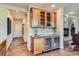 Kitchen bar area with custom cabinets, wine fridge and tile backsplash at 7083 Turweston Ln, Castle Pines, CO 80108