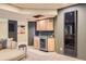 Finished basement featuring a wet bar with wood cabinets, a wine cooler, and a sofa at 7083 Turweston Ln, Castle Pines, CO 80108
