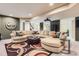 Finished basement with a sectional sofa, a large patterned rug, and neutral colored walls at 7083 Turweston Ln, Castle Pines, CO 80108