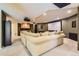 Basement features a large sectional, projector, wet bar, and movie screen for entertainment at 7083 Turweston Ln, Castle Pines, CO 80108