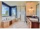 Bathroom features a luxurious soaking tub, a glass enclosed shower, and granite countertops at 7083 Turweston Ln, Castle Pines, CO 80108