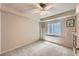 Empty bedroom with neutral walls and carpet flooring, a ceiling fan, and a window at 7083 Turweston Ln, Castle Pines, CO 80108