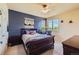 Well-lit bedroom features large windows, comfortable furnishings, and stylish decor at 7083 Turweston Ln, Castle Pines, CO 80108