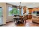 Bright dining area with a large window and wooden table at 7083 Turweston Ln, Castle Pines, CO 80108
