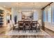 Elegant dining room featuring an oversized table with statement lighting at 7083 Turweston Ln, Castle Pines, CO 80108