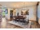 Elegant dining room featuring an oversized table with statement lighting at 7083 Turweston Ln, Castle Pines, CO 80108