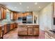 Spacious kitchen with custom wood cabinets, stainless steel appliances, and large center island at 7083 Turweston Ln, Castle Pines, CO 80108