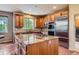 Kitchen with stainless appliances, center island with gas cooktop, and tile backsplash at 7083 Turweston Ln, Castle Pines, CO 80108