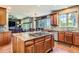 Open concept kitchen with island cooktop that overlooks a dining area and Gathering room at 7083 Turweston Ln, Castle Pines, CO 80108