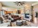 Open-concept living space with hardwood floors, fireplace, and comfortable seating at 7083 Turweston Ln, Castle Pines, CO 80108