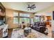 Inviting living room with a ceiling fan, large windows, and comfortable seating at 7083 Turweston Ln, Castle Pines, CO 80108
