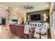 Inviting living room with stone fireplace, hardwood floors, and cozy seating area at 7083 Turweston Ln, Castle Pines, CO 80108