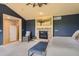 Main bedroom with a fireplace, sitting area and large window at 7083 Turweston Ln, Castle Pines, CO 80108