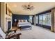Main bedroom featuring a fireplace, ceiling fan, and large windows with views at 7083 Turweston Ln, Castle Pines, CO 80108