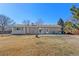 Large backyard featuring a patio with outdoor seating, ample space for recreation, and mature trees at 12500 Meade Ct, Broomfield, CO 80020