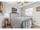 Bedroom with a metal frame bed, wood laminate flooring, and a sunny window at 12500 Meade Ct, Broomfield, CO 80020