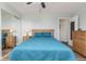 Bright bedroom with a ceiling fan, a large mirror sliding door closet, and wood laminate flooring at 12500 Meade Ct, Broomfield, CO 80020