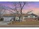 Charming single-story home with a well-manicured lawn, a two-car garage and inviting curb appeal at 12500 Meade Ct, Broomfield, CO 80020