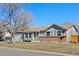 Charming single-story home with a well-manicured lawn, a two-car garage and inviting curb appeal at 12500 Meade Ct, Broomfield, CO 80020