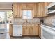 Kitchen featuring light wood cabinets, a large sink window, and white appliances at 12500 Meade Ct, Broomfield, CO 80020