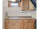 Basement kitchenette with stainless steel sink, wood cabinets, and a durable countertop at 12500 Meade Ct, Broomfield, CO 80020