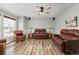 Cozy living room featuring hardwood floors, ample seating, and a ceiling fan for comfort at 12500 Meade Ct, Broomfield, CO 80020