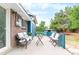 Back porch with seating area and view of a shed and surrounding greenery at 544 S Victor Way, Aurora, CO 80012