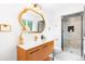 Bathroom with modern vanity, stylish mirror, and walk-in shower with a tiled surround at 544 S Victor Way, Aurora, CO 80012