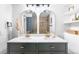 Modern bathroom featuring dual sinks, stylish mirrors, a toilet, and elegant fixtures at 544 S Victor Way, Aurora, CO 80012