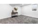 Bright, empty room with a console table, minimalist decor, and a large window at 544 S Victor Way, Aurora, CO 80012