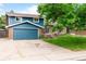 Charming two-story home with a blue exterior, brick accents, an attached garage, and a well-maintained front yard at 544 S Victor Way, Aurora, CO 80012