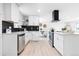Well-equipped kitchen with stainless steel appliances, sleek white cabinets, and a modern backsplash for a contemporary feel at 544 S Victor Way, Aurora, CO 80012