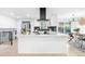 Modern kitchen with a large island, stainless steel appliances, and black backsplash creating a stylish and functional space at 544 S Victor Way, Aurora, CO 80012