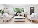 Sun-filled living room showcases modern decor, hardwood floors, and a large window with views of the lush greenery at 544 S Victor Way, Aurora, CO 80012