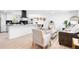 Bright, open-concept living space seamlessly connects the kitchen, dining area, and living room with ample natural light at 544 S Victor Way, Aurora, CO 80012
