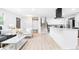 Open floor plan featuring living room, kitchen with island, staircase, and bright natural light, ideal for gatherings at 544 S Victor Way, Aurora, CO 80012