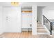 Bright mud room features custom storage, built-in bench, and easy access to the staircase with iron railing at 544 S Victor Way, Aurora, CO 80012
