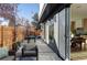 Long backyard patio with seating area and access to kitchen at 2471 Quitman St, Denver, CO 80212