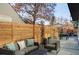 Modern backyard patio with seating area and wood privacy fence at 2471 Quitman St, Denver, CO 80212