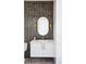 Powder room with dark tile and an oval mirror at 2471 Quitman St, Denver, CO 80212