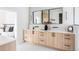 Modern bathroom with light wood cabinets and a large vanity at 2471 Quitman St, Denver, CO 80212