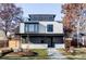 Modern two-story home with a flat roof, large windows, a covered porch, and manicured landscaping at 2471 Quitman St, Denver, CO 80212